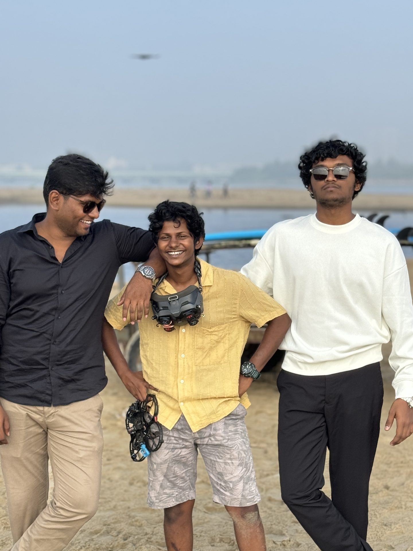 Chugilan at the beach with the crew — drone visible in the sky above